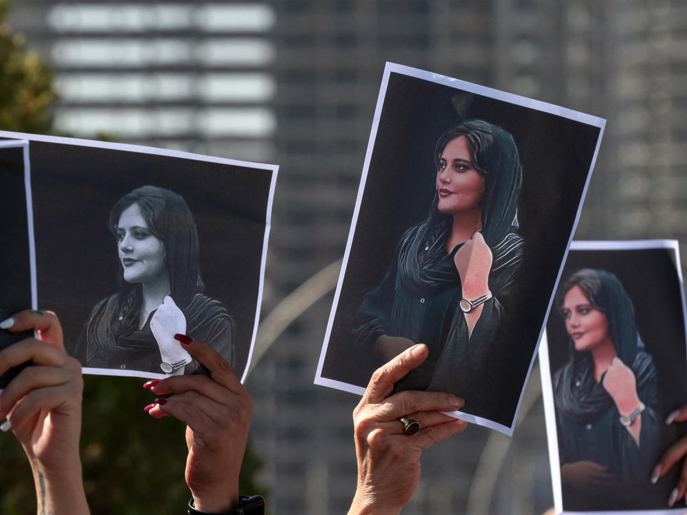 Women hold up signs depicting the image of 22-year-old Mahsa Amini, who died while in the custody of Iranian authorities, during a demonstration denouncing her death by Iraqi and Iranian Kurds outside the U.N. offices in Arbil, the capital of Iraq's autonomous Kurdistan region, on Sept. 24, 2022.