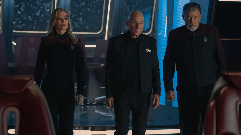 Jeri Ryan as Seven of Nine, Patrick Stewart as Picard, and Jonathan Frakes as Riker.