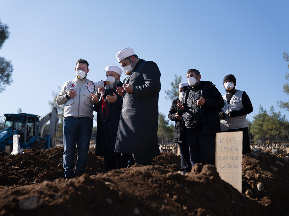 A funeral ceremony is performed at a mass grave site in Kahramanmaras, Turkey, where thousands of bodies from the earthquake are already buried and more graves are still being dug.