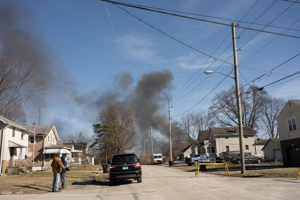 Smoke rises from the derailed train on Feb. 4, the day after the crash.