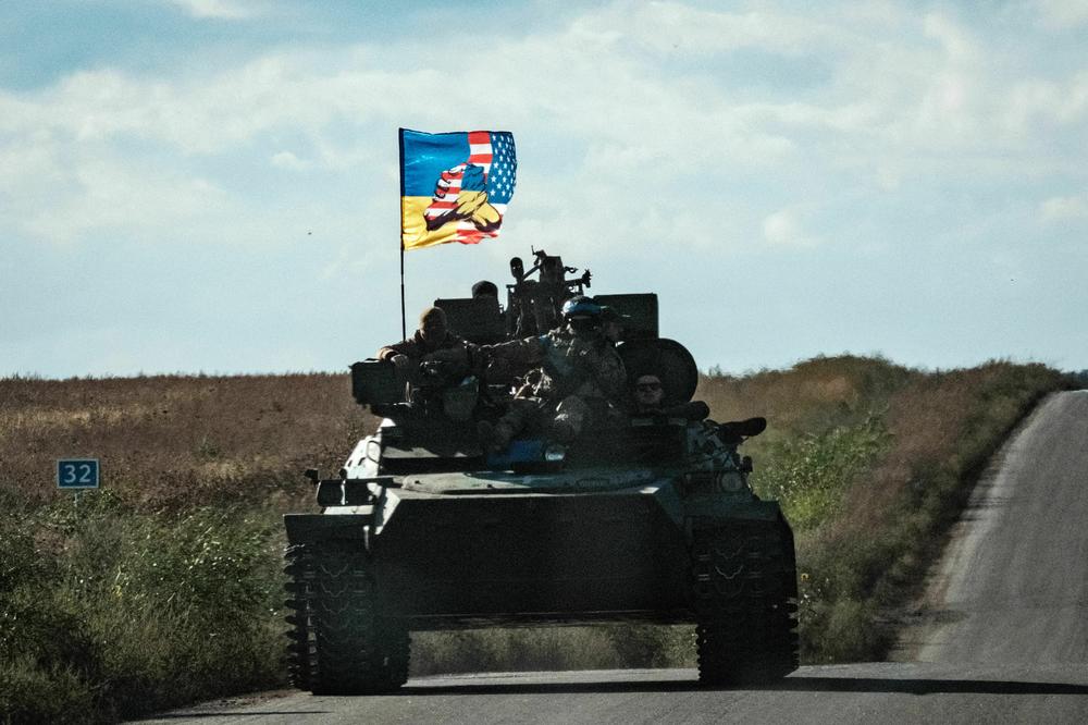 A Ukrainian tank moving through Novostepanivka, Kharkiv region on Sept. 19, 2022 flies a flag representing Ukrainian and American cooperation.