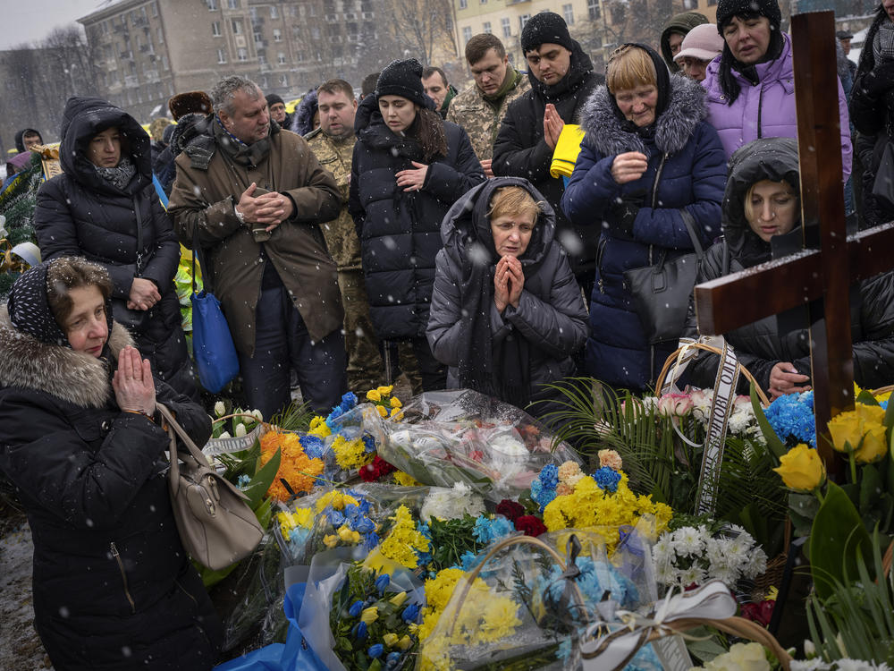 Nadia (center) prays at the grave of her son Oleg Kunynets, a Ukrainian military serviceman who was killed in the east of the country, during his funeral in Lviv, Ukraine, on Feb. 7.