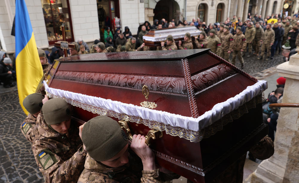 Ukrainian soldiers carry the coffins of two fellow soldiers at their funeral Friday at the Church of the Most Holy Apostles Peter and Paul in the western Ukrainian city of Lviv.