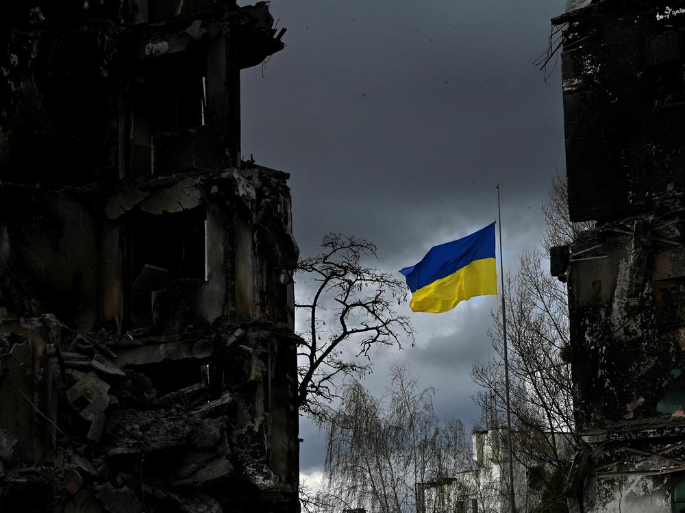 The Ukrainian flag flutters between buildings destroyed in bombardment in the Ukrainian town of Borodianka. It was one year ago last week that Russia invaded.