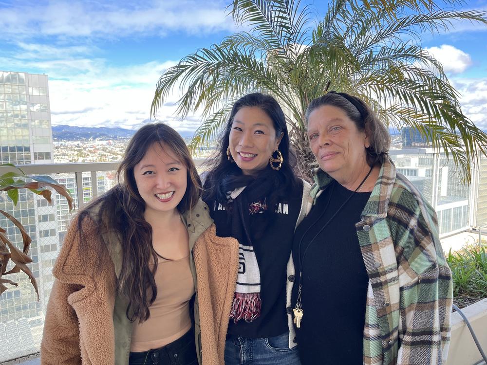 Kristina Wong (center) on a Koreatown apartment building roof flanked by fellow neighborhood council members Jeong Lynn Stransky (left) and Angie Brown (right.)