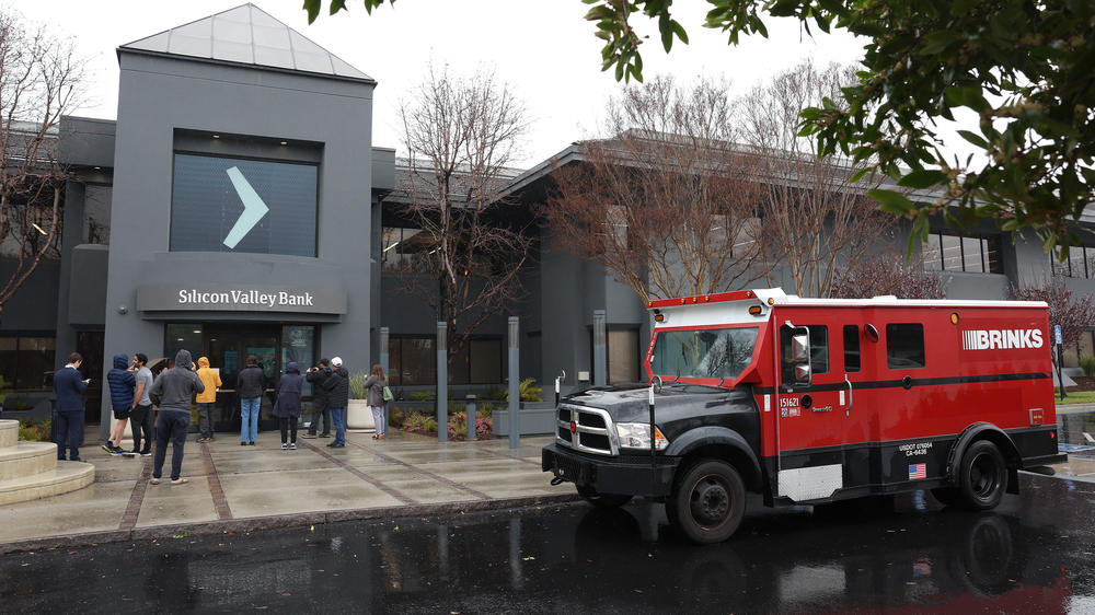 A Brinks armored truck sits in front of the shuttered Silicon Valley Bank headquarters in Santa Clara, Calif., on March 10. Regulators shut the bank down and say all deposits are backstopped.