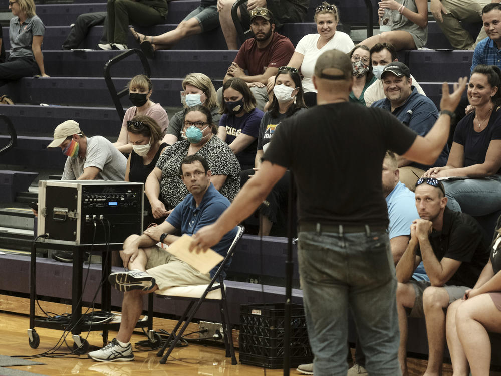 People speak during a special Board of Education Meeting on mask mandates for students and staff in Kalamazoo County Schools at the Schoolcraft High School Gymnasium on August 23, 2021 in Schoolcraft, Michigan. The Schoolcraft Local School District opened the floor for public discussion.