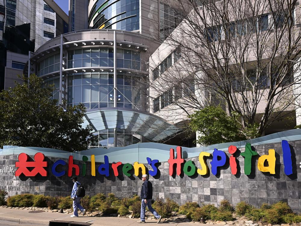 People walk past the Monroe Carell Jr. Children's Hospital at Vanderbilt, in Nashville, Tenn., on Monday, where victims were taken after a shooting at the Covenant School.