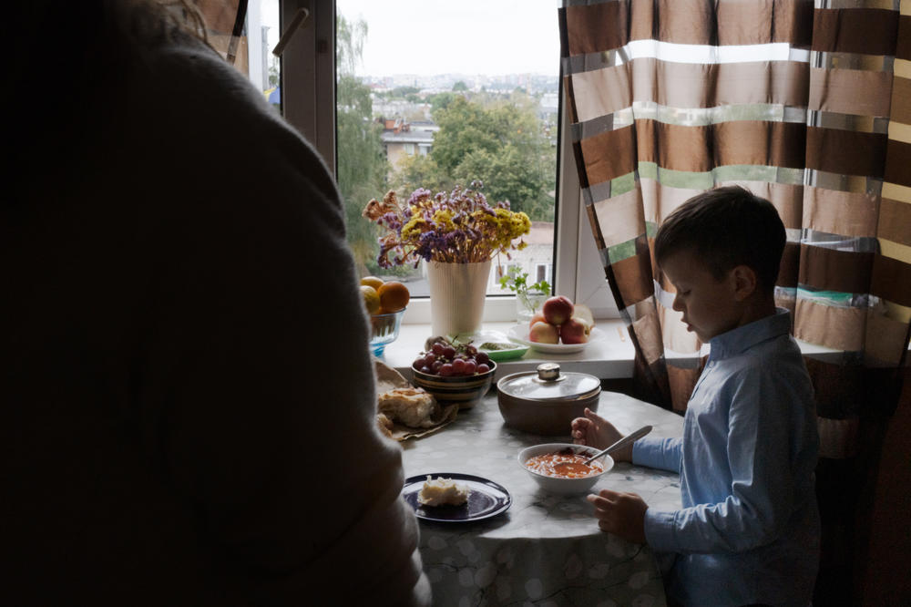 Bohdan eats borscht after school in the apartment his family is borrowing from a friend in Lviv, Ukraine.