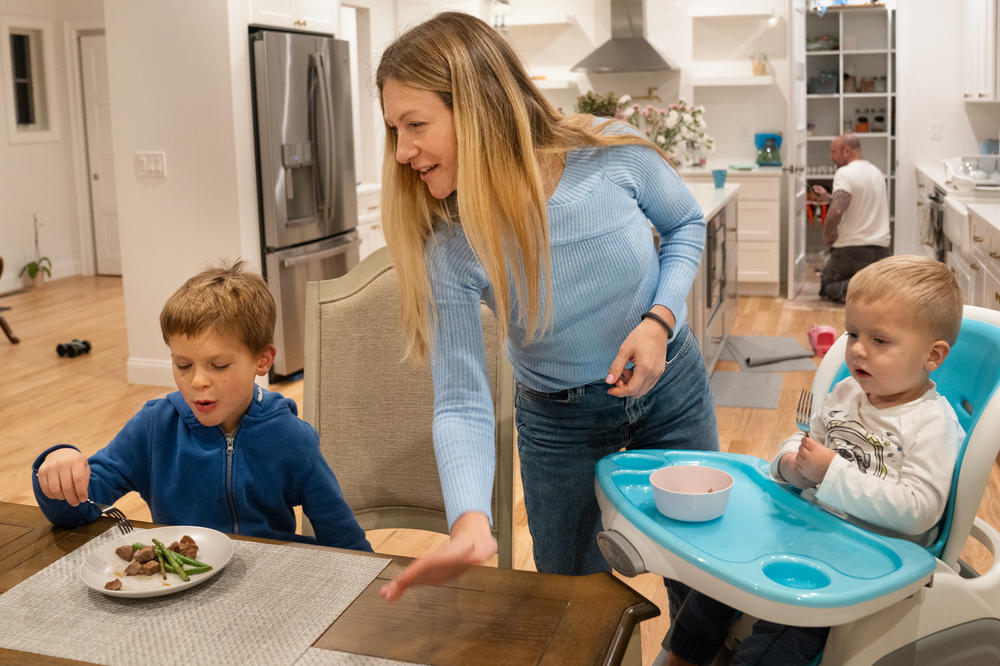 Kristina Bizyayev, Daniel's mom, makes dinner for Daniel and his youngest brother, Leo.