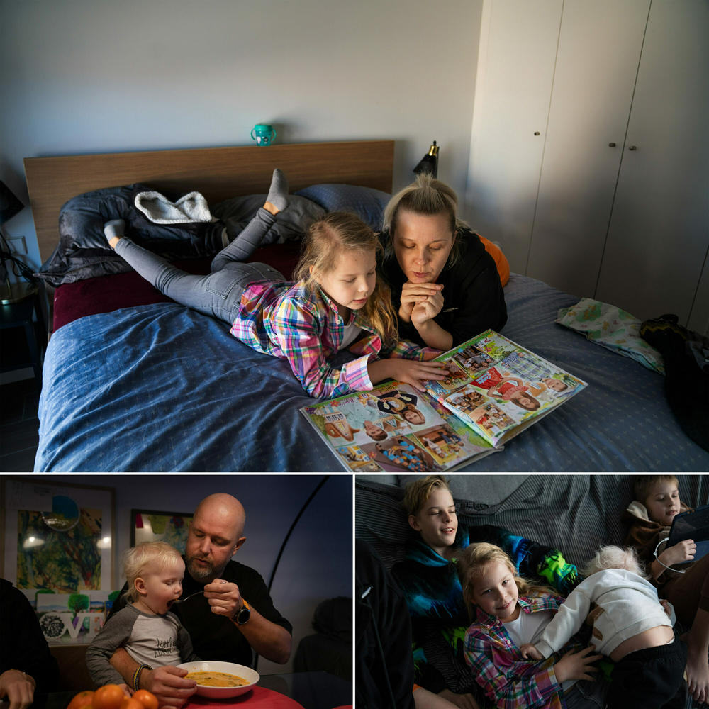 Above: Aurora and her mom, Maryna, look through the yearbook from the kindergarten class in Kharkiv. Below: The Demchenko family in their high-rise apartment in Valencia.