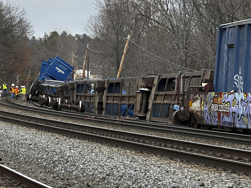 Officials work at the scene of a derailed freight train with no hazardous materials, Thursday, March 23, 2023, in Ayer, Mass.