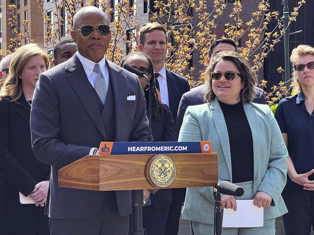 New York Mayor Eric Adams, left, introduces Kathleen Corradi, center, as the first-ever citywide director of rodent mitigation, also known as the 