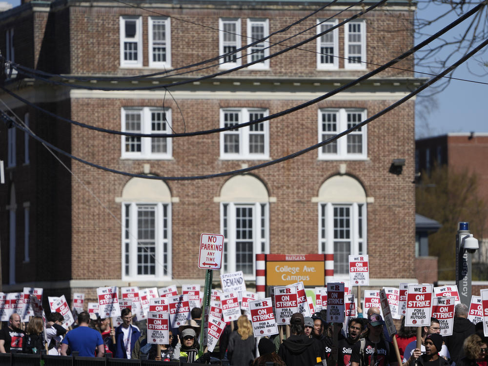 Strikers march in front of Rutgers' buildings in New Brunswick, N.J., this past Monday.