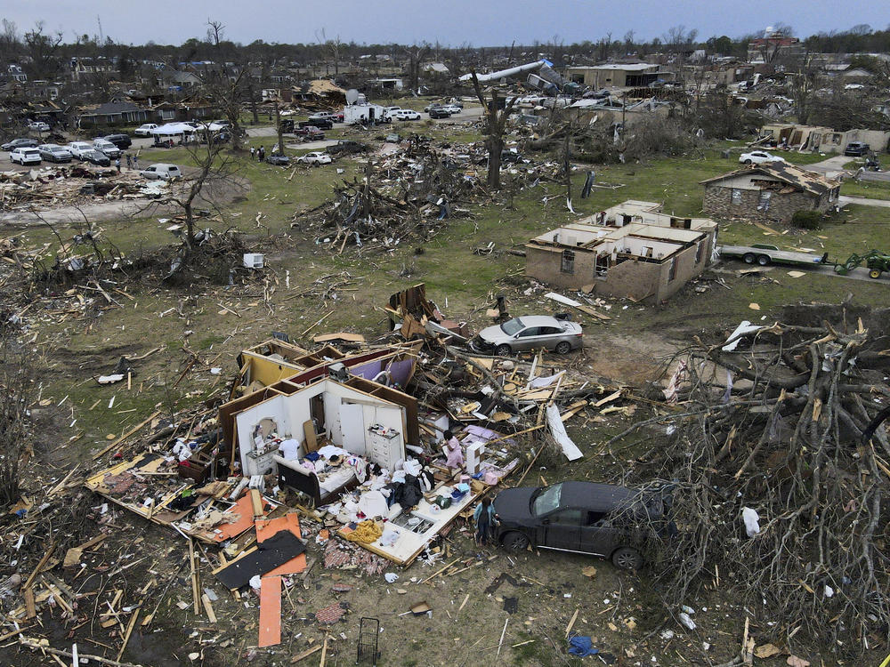 Debris is strewn about tornado-damaged homes in Rolling Fork, Miss., in March, 2023.