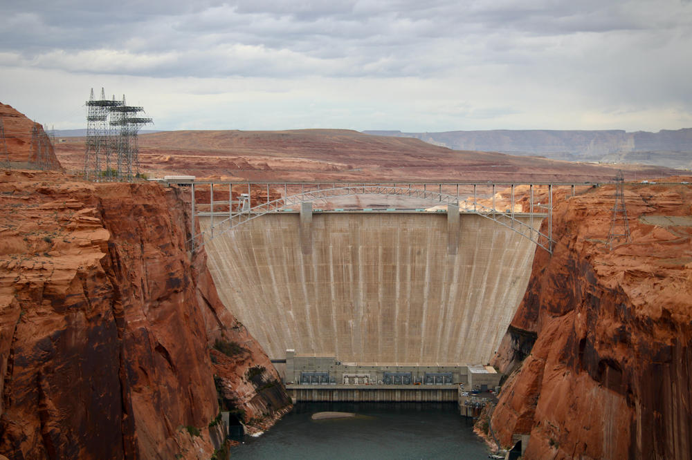 Glen Canyon Dam holds back Lake Powell near Page, Ariz. Water levels behind the dam have dropped so low that invasive smallmouth bass are able to swim downstream and now threaten native fish in the Grand Canyon.