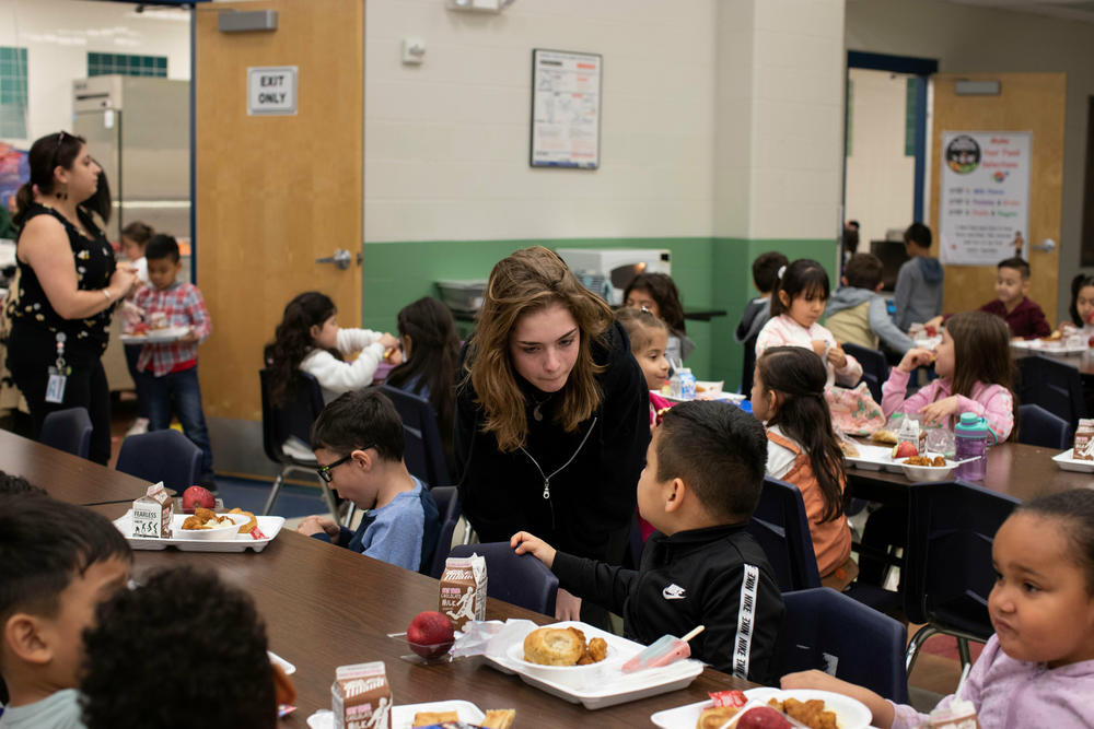 CAST Teach student Heather Faulkner, 14, helps a class during lunch at Forester Elementary.