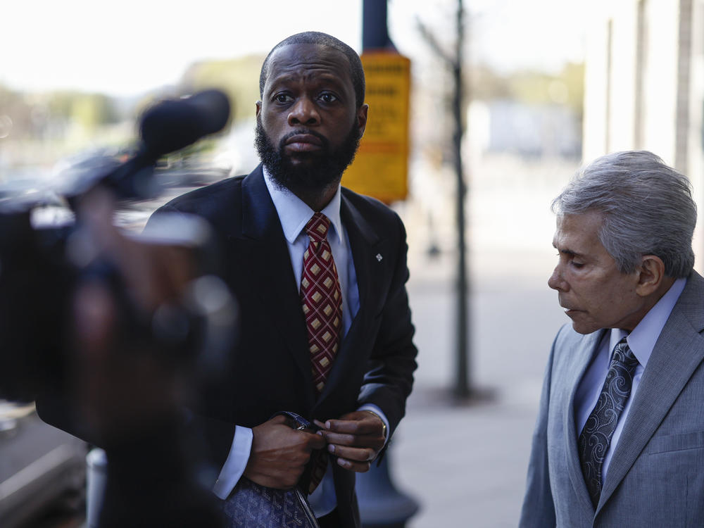 Pras Michel, former member of the Fugees, center, and his lawyer David Kenner arrive to federal court in Washington, D.C., on April 3, 2023.
