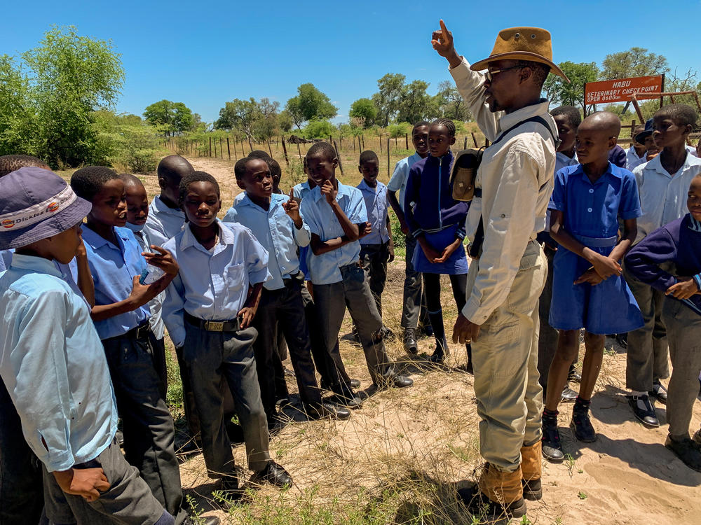 Before the drive begins, safari guide Moreetsi Tsile asks the children which animal they're most hoping to see. 