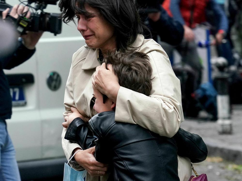A parent escorts her child following a shooting at a school in the capital Belgrade on Wednesday.