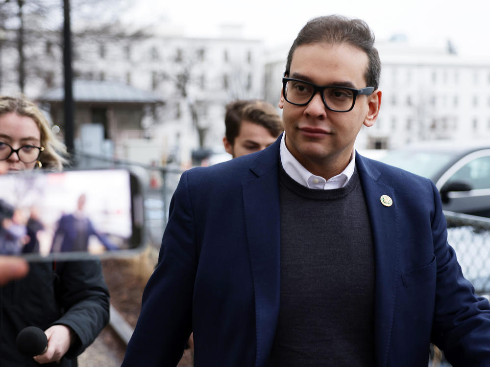U.S. Rep. George Santos leaves the Capitol Hill Club as members of the press follow him on Jan. 31 in Washington, D.C., amid ongoing investigations into his finances, campaign spending and false statements on the campaign trail.
