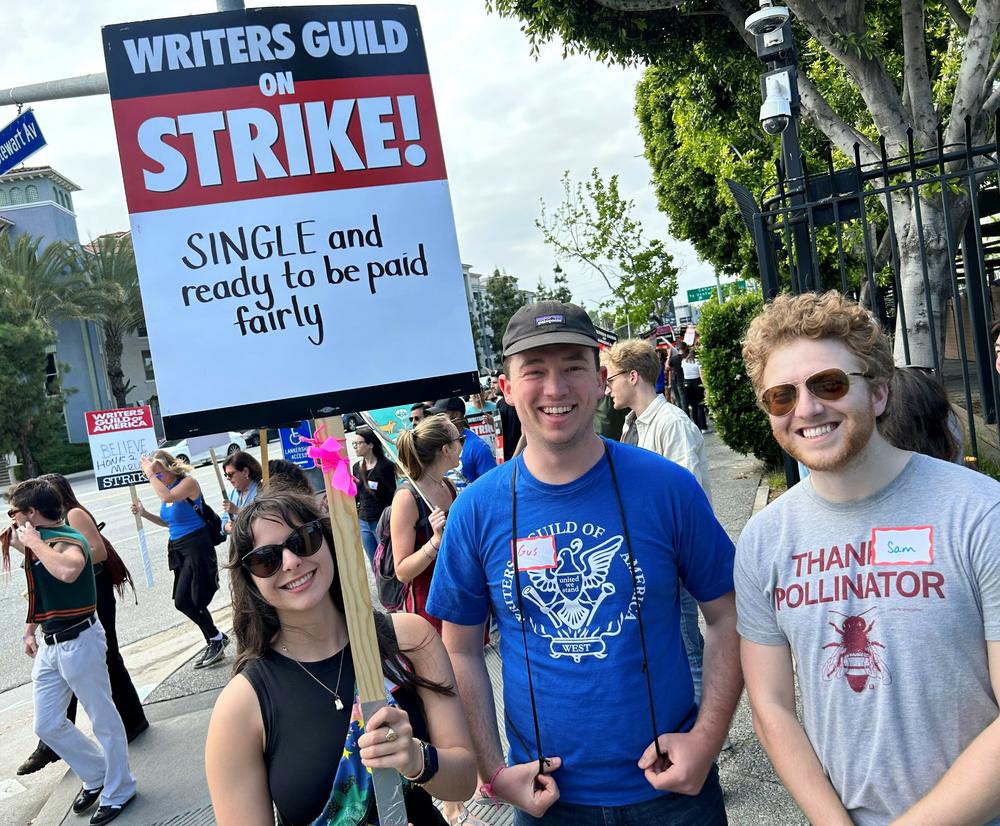 Until the strike, Haley Boston (left) had been developing a horror show for Netflix called <em>Something Very Bad is Going to Happen</em>. Now, she's hoping something very good comes out of their protests. Augustus Schiff and Sam Freedman stand to her right.