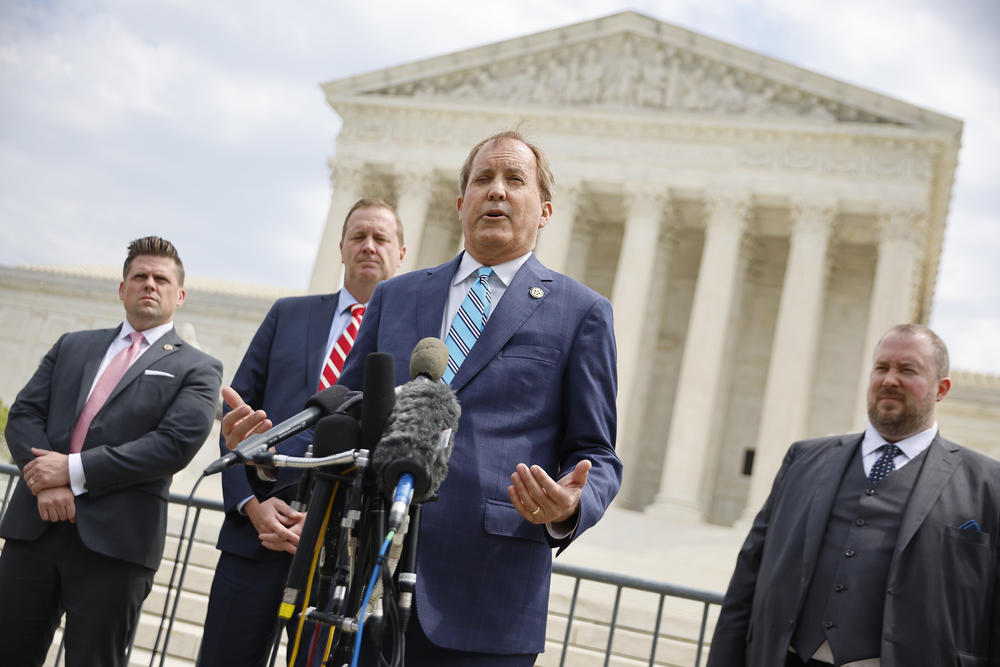 Texas Attorney General Ken Paxton (C) talks to reporters with former Missouri Attorney General Eric Schmitt (2nd L) and Texas Solicitor General Judd Stone (R) in front of the U.S. Supreme Court after arguments in their case about Title 42 on April 26, 2022 in Washington, DC.