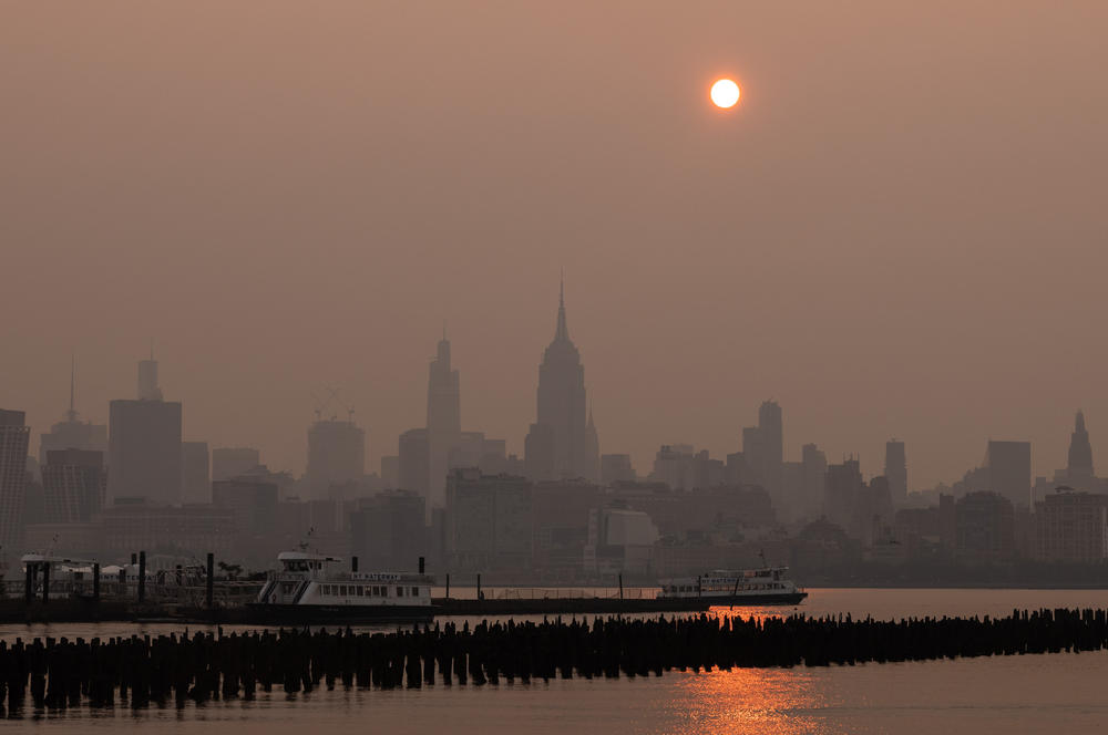 Buildings in the Manhattan skyline shrouded in smoke from Canada wildfires at sunrise in Jersey City, New Jersey, on Weds., June 7, 2023. New York was the most polluted major city in the world on Tuesday night, as smoke from Canadian wildfires blanketed the city in haze.