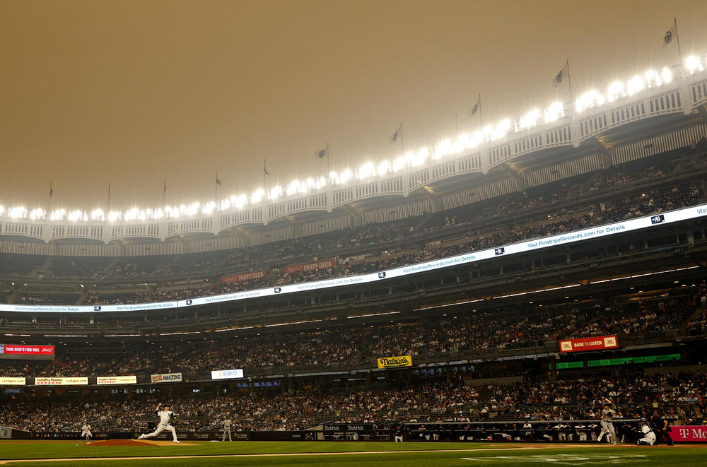 General view of hazy conditions resulting from Canadian wildfires as Clarke Schmidt #36 of the New York Yankees pitches during the first inning against the Chicago White Sox at Yankee Stadium on June 06, 2023 in the Bronx borough of New York City.