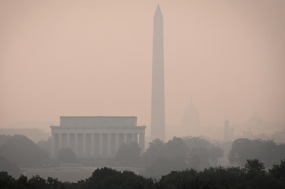 Hazy skies caused by Canadian wildfires blanket the monuments and skyline of Washington, D.C. on June 7, 2023 as seen from Arlington, Virginia. The Washington DC area is under a Code Orange air quality alert indicating unhealthy air for some members of the general public.