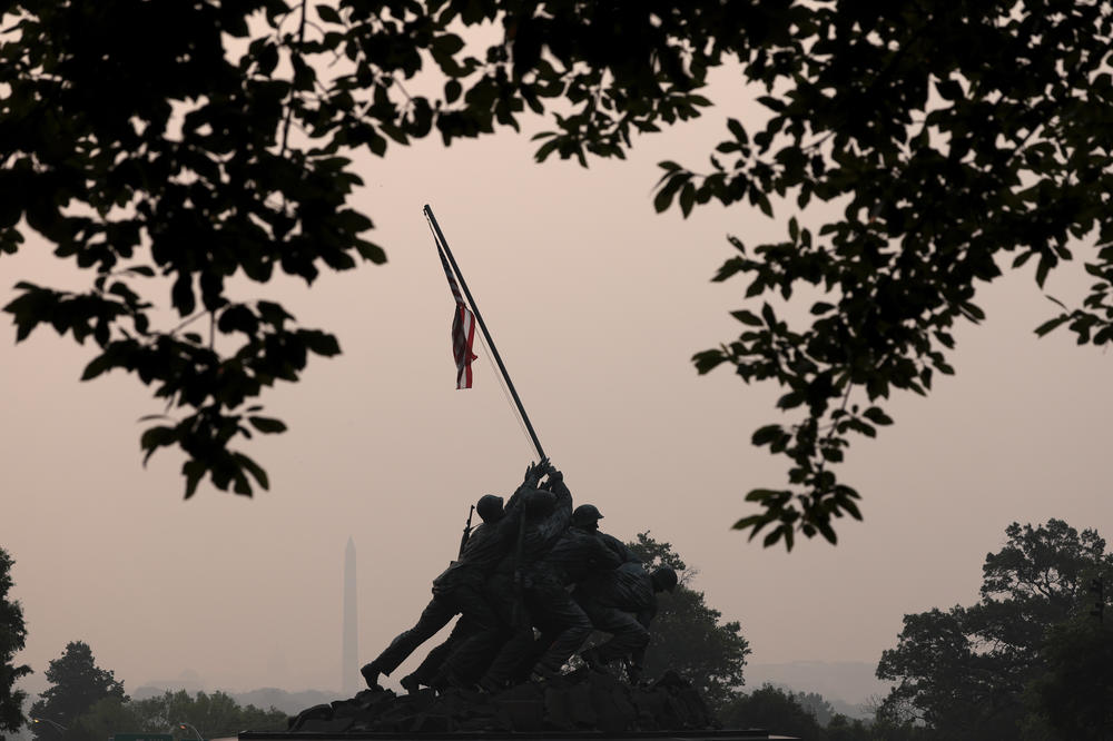 Hazy skies caused by Canadian wildfires blanket the monuments and skyline of Washington, D.C. on June 7, 2023 as seen from Arlington, Virginia.