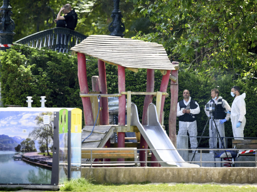 Security forces gather in a playground at the scene of knife attack in Annecy, a town in the French Alps, on Thursday.