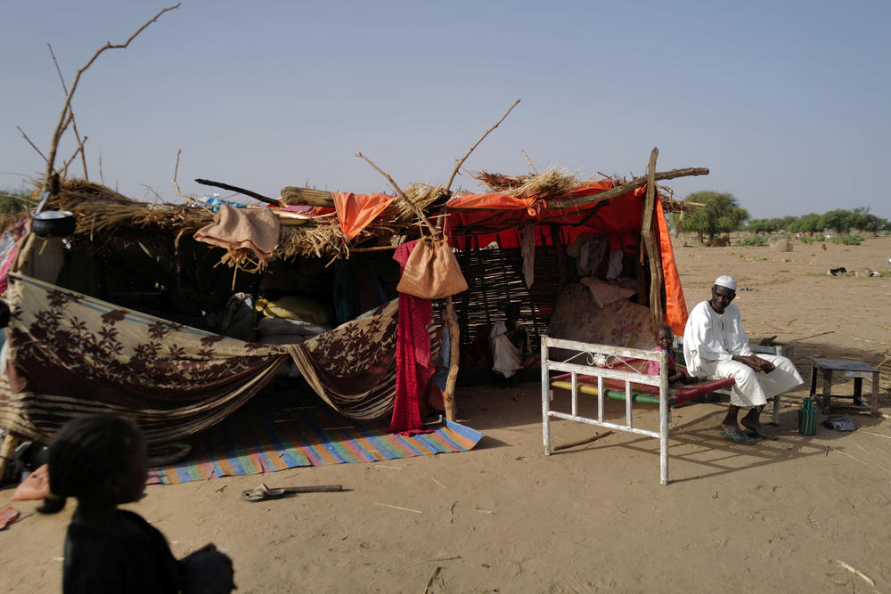 Ismail Haroun, a Sudanese refugee who has fled the violence in Sudan's Darfur region, sits beside his makeshift shelter near the border between Sudan and Chad in Koufroun, Chad, on May 15.