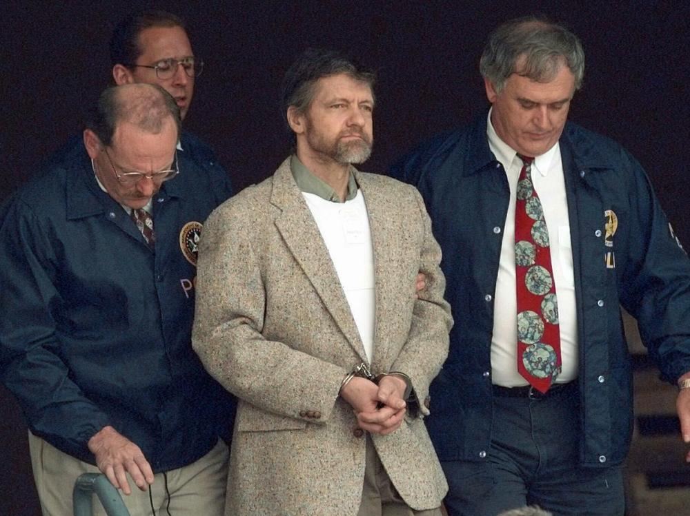 U.S. Marshals prepare to take Theodore Kaczynski down the steps at the federal courthouse to a waiting vehicle on June 21, 1996, in Helena, Mont. A spokesperson for the Bureau of Prisons told The Associated Press on Saturday that Kaczynski, known as the 