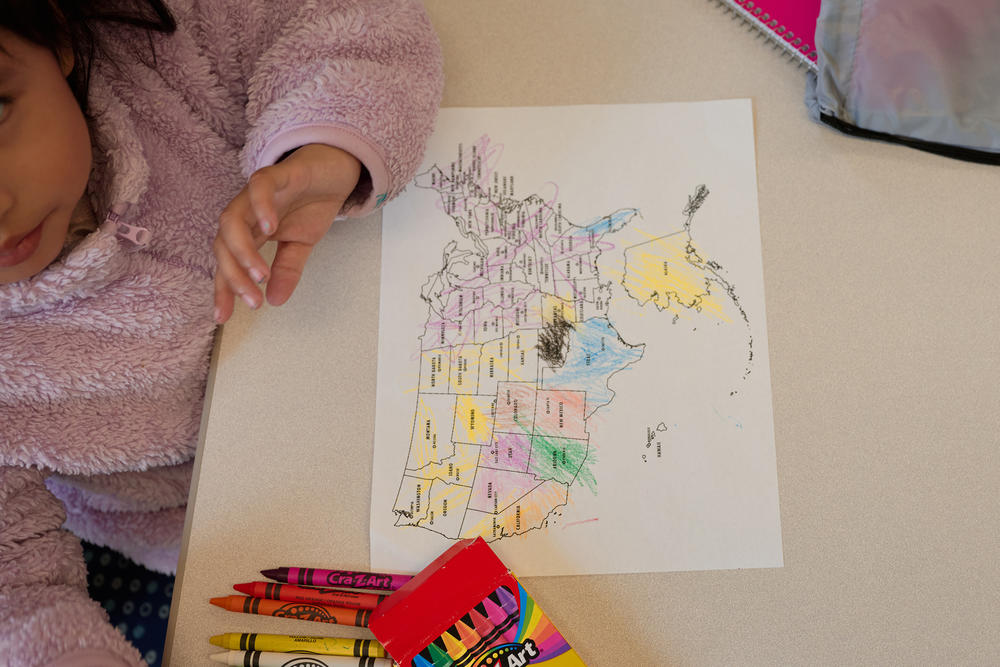 A young girl colors a U.S. map during her mother's ESL class this month at Capital District Latinos in Albany, N.Y.