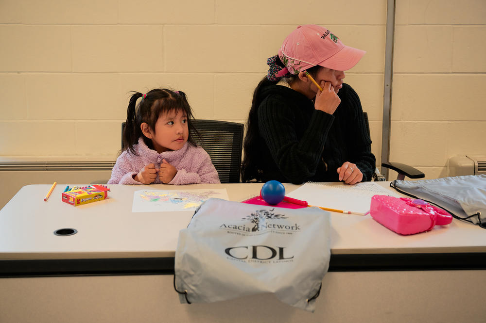 A young girl and her mom sit in an ESL class at Capital District Latinos in Albany, N.Y., earlier this month.