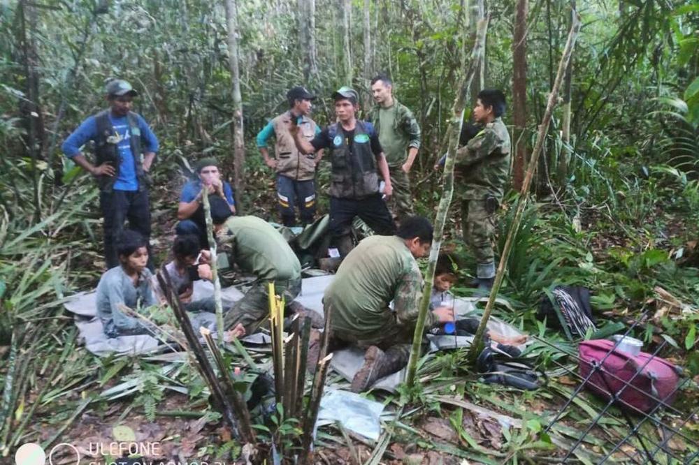 Colombian military forces help four children who survived 40 days in the Amazon jungle after their plane crashed in the department of Caqueta on June 9.