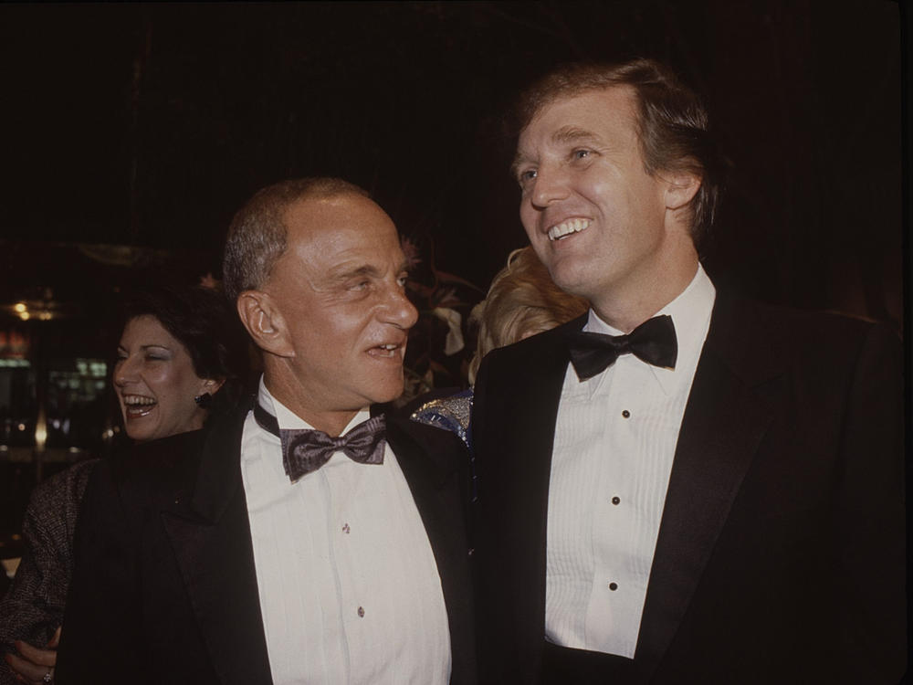 Roy Cohn (left) and Donald Trump attend the Trump Tower opening in New York City in October 1983.
