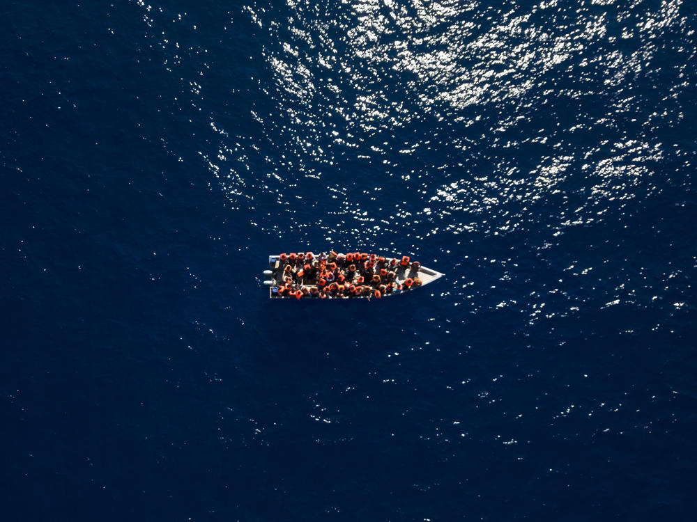 Migrants from Eritrea, Libya and Sudan sail a wooden boat before being assisted by aid workers of the Spanish NGO Open Arms, in the Mediterranean sea, about 30 miles north of Libya, Saturday, June 17, 2023.