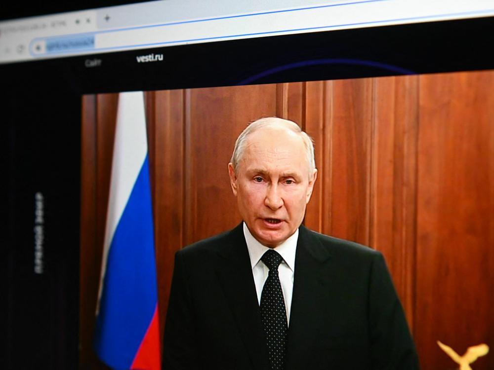 Russia's President Vladimir Putin, seen on a laptop screen, makes a statement in Moscow on Saturday as Wagner Group forces stage a rebellion.