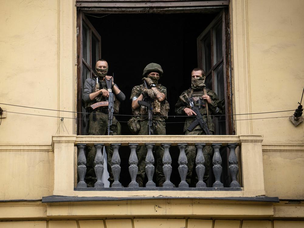 Members of Wagner Group stand on the balcony of a building in the city of Rostov-on-Don on Saturday, June 24.