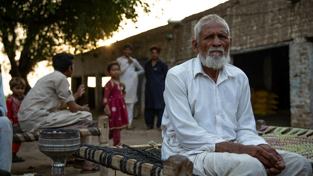 Muhammad Aslam, whose sons Qasim and Munir are still missing from the shipwreck, sits near his house in Noor Jamal village, Punjab province, Pakistan on June 22, 2023.
