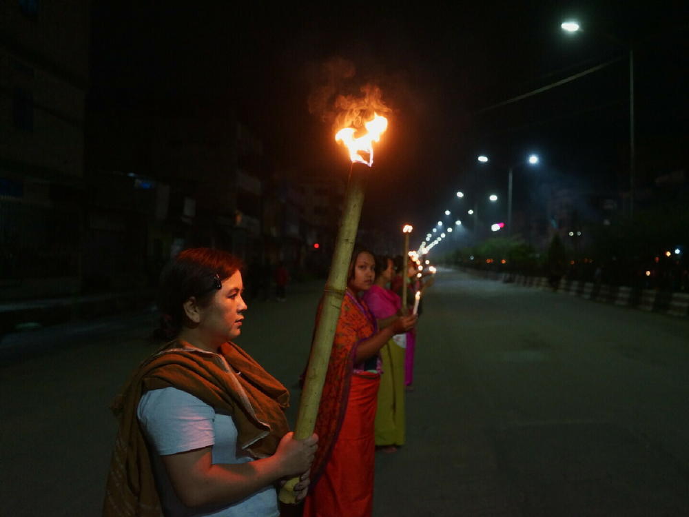 Women protesters in Imphal hold a torchlight vigil and demand an end to the violence.