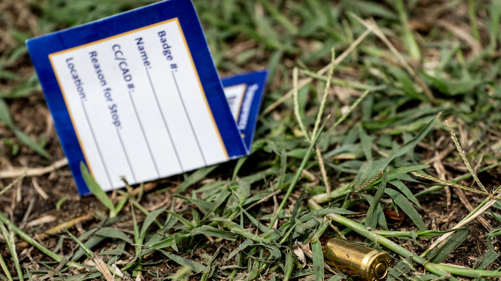 A bullet casing is seen at the site of a mass shooting in the Brooklyn Homes neighborhood in Baltimore, Maryland, on Sunday. Two people were killed and 28 others were wounded during the shooting at a block party on Saturday night.