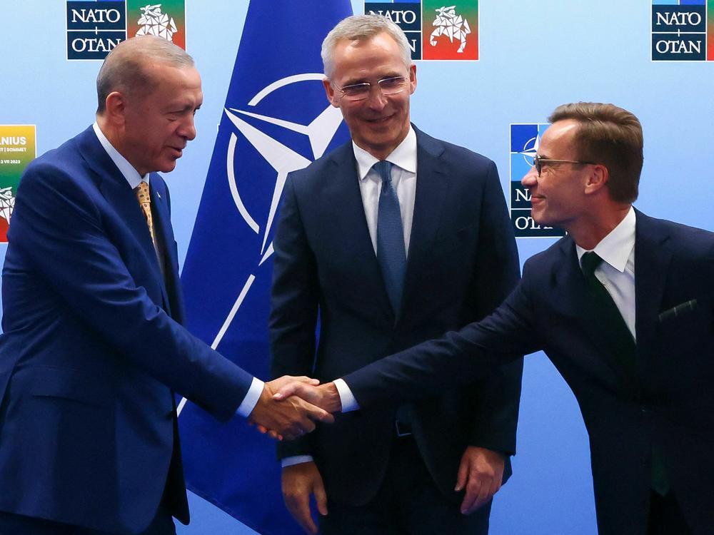 Turkish President Tayyip Erdogan (left) and Swedish Prime Minister Ulf Kristersson shake hands in front of NATO Secretary-General Jens Stoltenberg prior to their meeting, on the eve of a NATO summit, in Vilnius, Lithuania, on Monday.