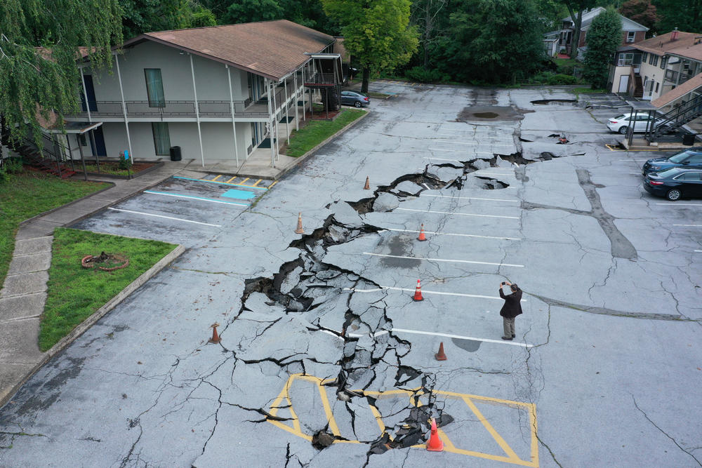 An aerial view shows damage to a parking lot after historic rainfall north of New York City triggered dozens of water rescues and led to roadways being washed out after more than a half-foot of rain fell in only a few hours Sunday in Orange County, N.Y., on Monday, July 10.