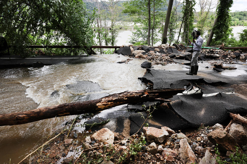 A severely damaged road is closed near Bear Mountain State Park following a night of heavy rain and flooding on Monday, July 10, in Highland Falls, N.Y.