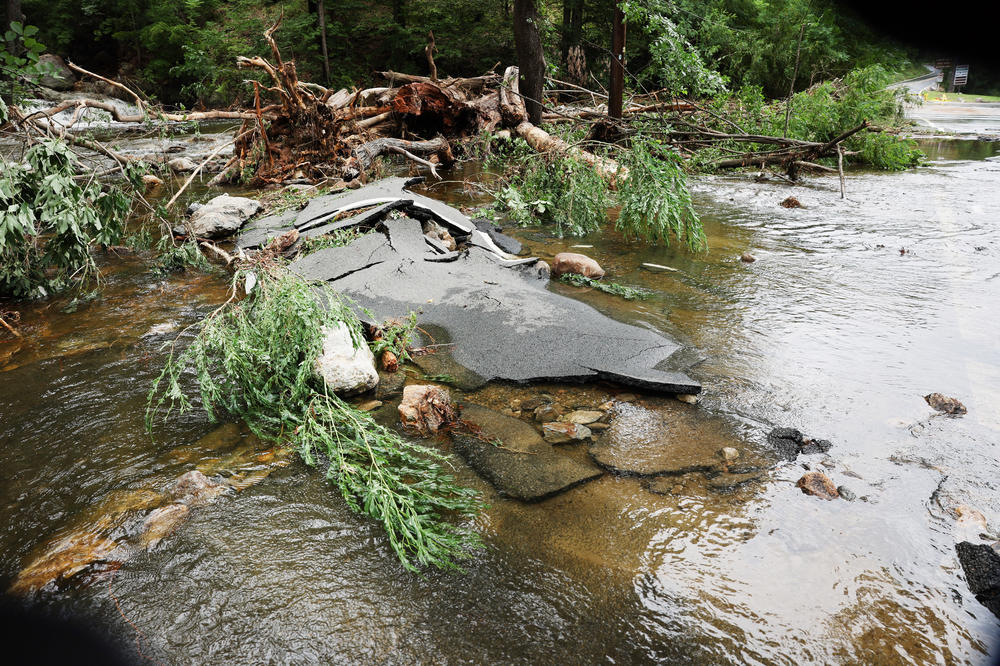 A severely damaged road is closed near Bear Mountain State Park following a night of heavy rain and flooding is pictured on Monday, July 10, in Highland Falls, N.Y.