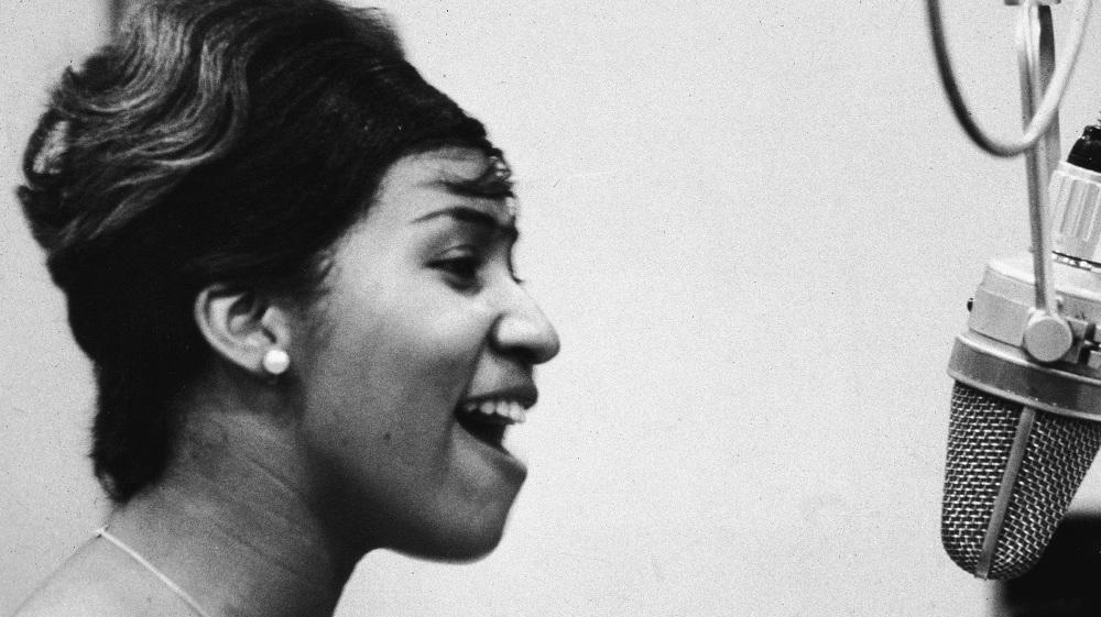 Aretha Franklin sings in the studio during her early career at Columbia Records.