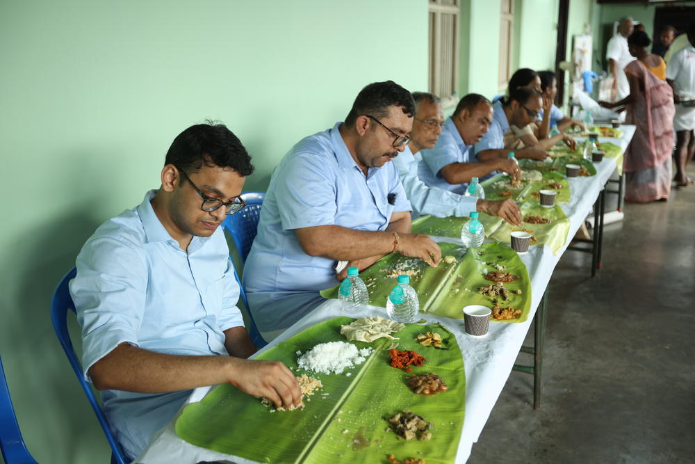Family members enjoy a festive meal — with 18 different foods — at the wedding vow renewal ceremony. Thousands of guests came, starting at 8 a.m., and were served breakfast and then later, lunch, on banana leaves.